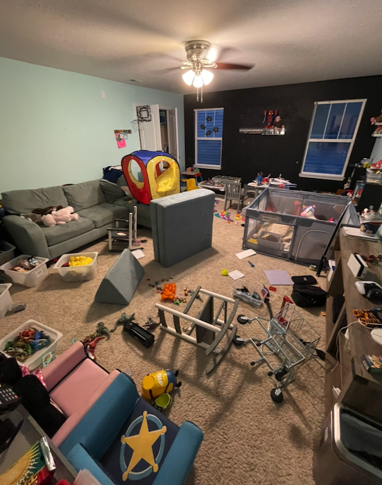 A family playroom with toys and boxes across the floor.