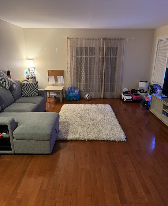 The same living room, floor clear and furniture reset.